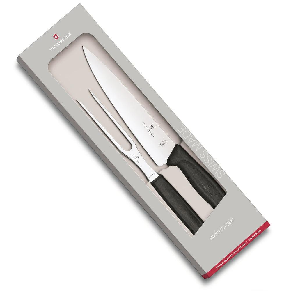 Carving knife and fork set, with polished steel blades and black ergonomic handles in Swiss Classic style, packaged in a gift box.